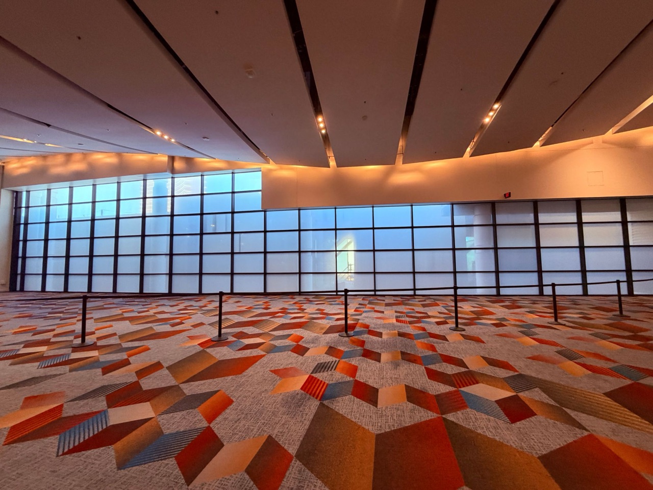 Convention center frosted window film — Frosted privacy film across a two-story curtain wall in a convention ballroom foyer — Las Vegas, NV