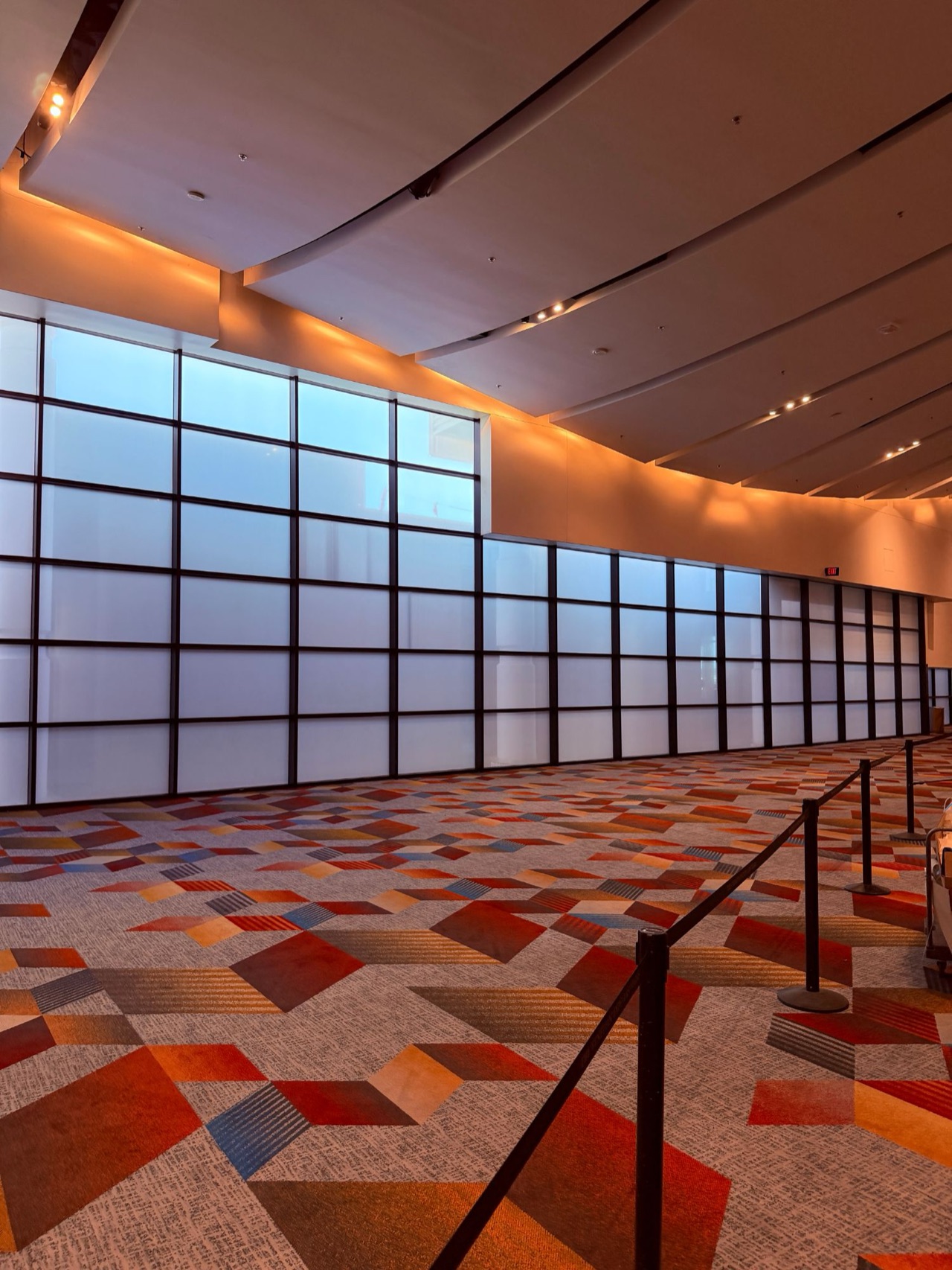 Convention center frosted window film — Frosted privacy film across a two-story curtain wall in a convention ballroom foyer — Las Vegas, NV