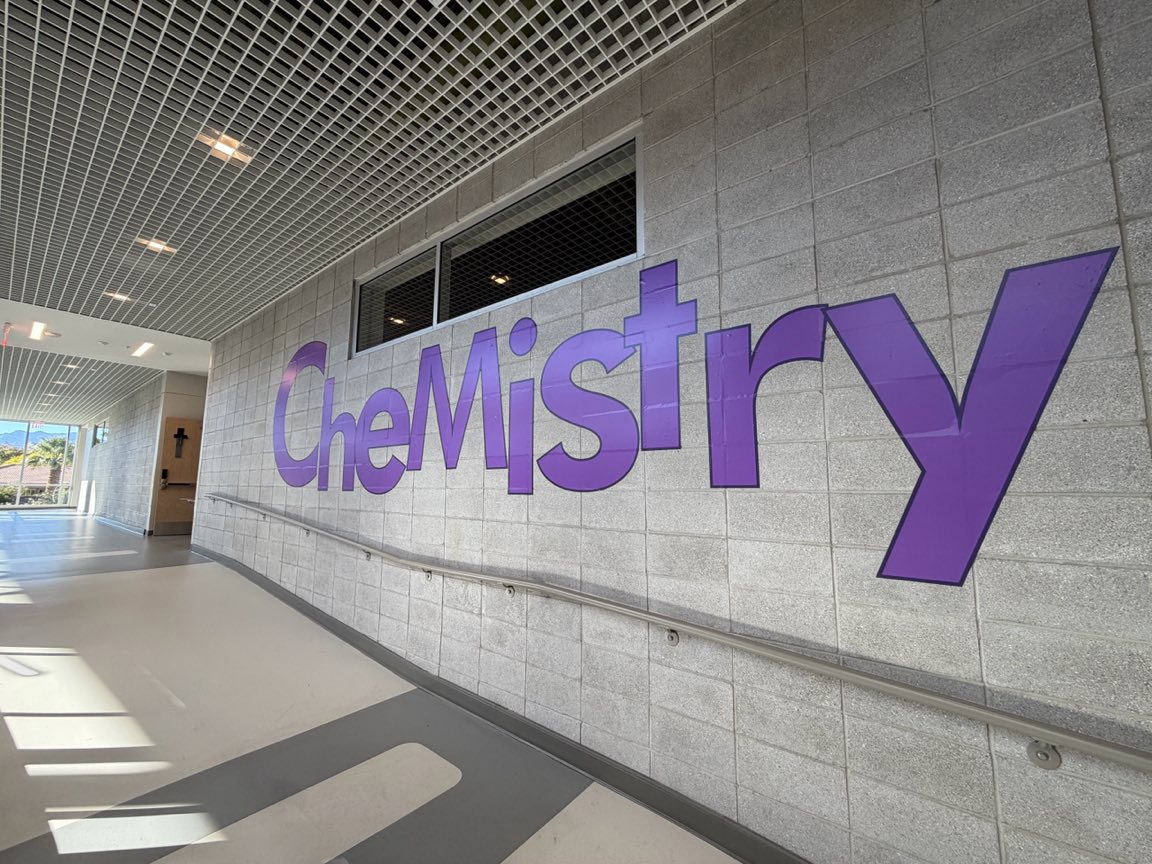Purple Chemistry lettering on a school block wall