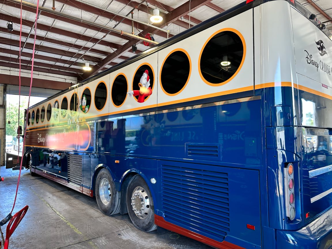 Disney Cruise Line motorcoach with a full navy and white wrap