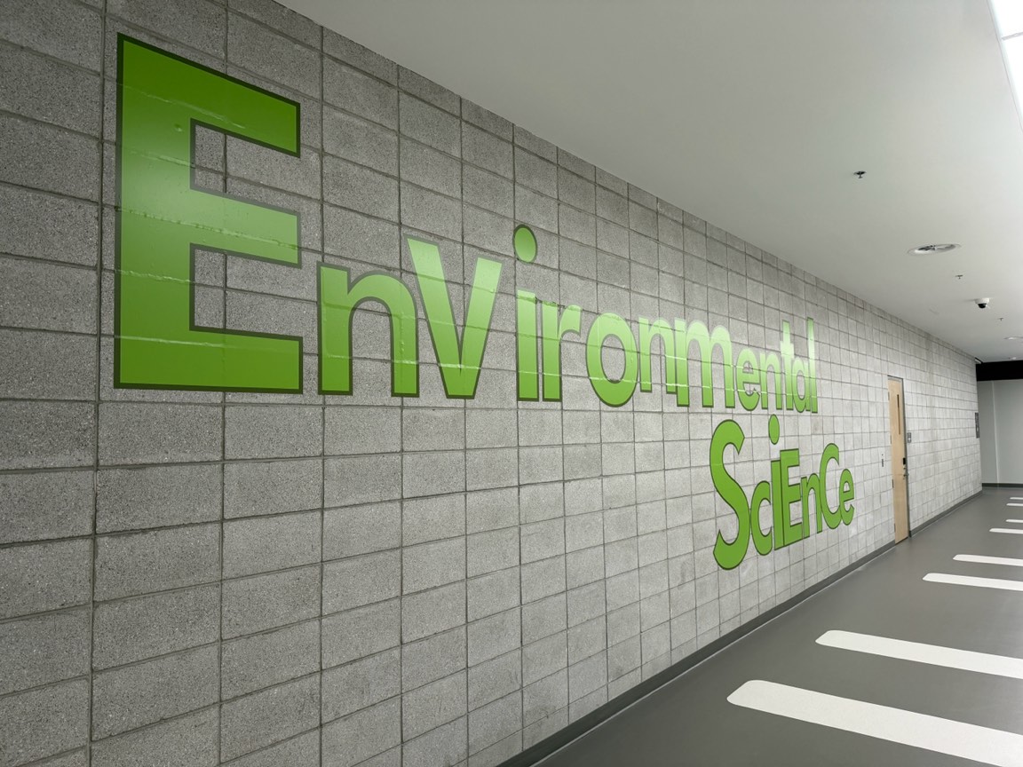Green Environmental Science lettering along a school hallway