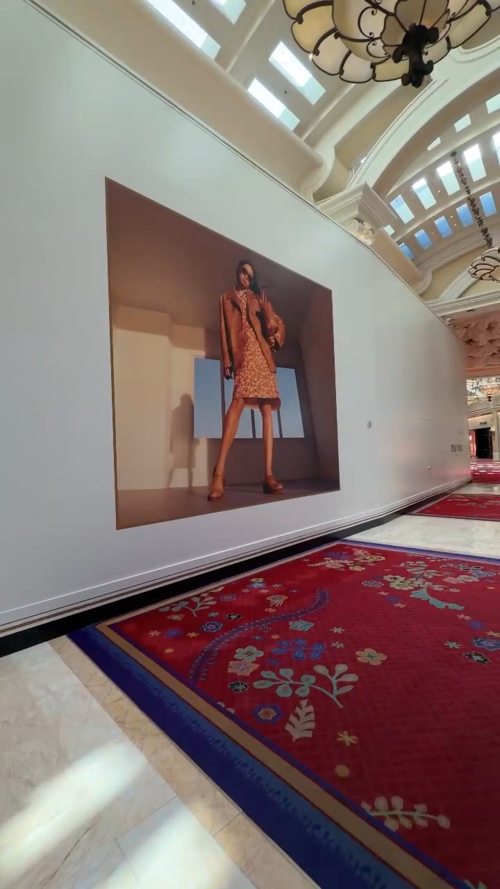 Video of Miu Miu opening soon barricade graphics in a luxury retail corridor