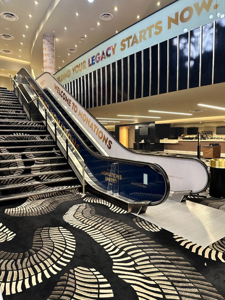 Monations escalator wrap and Building Your Legacy Starts Now header