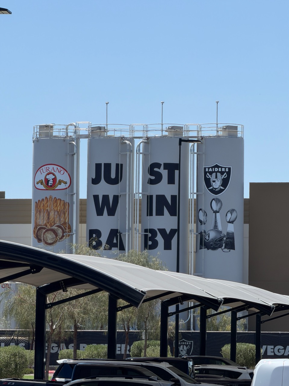 Four silos wrapped with Just Win Baby lettering, Turano Baking and Raiders logos
