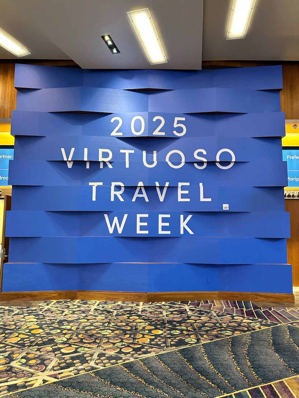 Blue dimensional Virtuoso Travel Week 2025 entrance wall