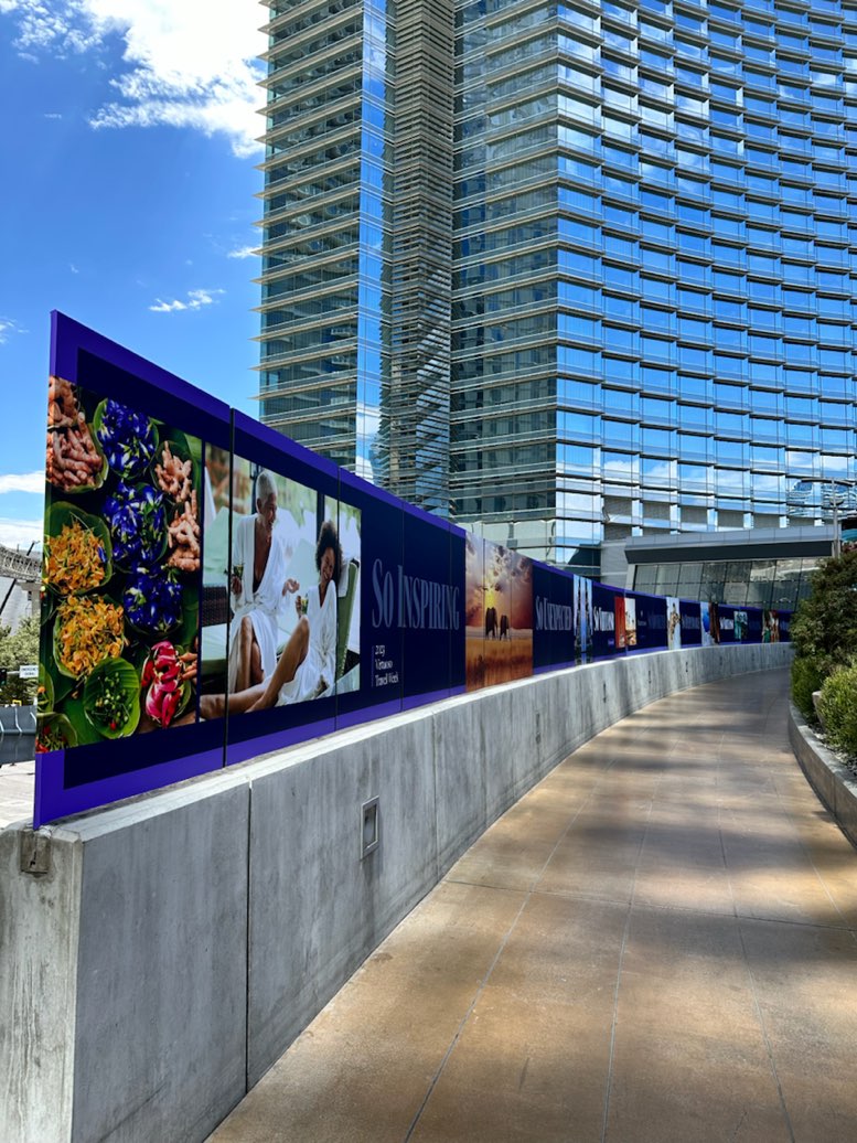Photo-printed construction fence wrap along an outdoor walkway